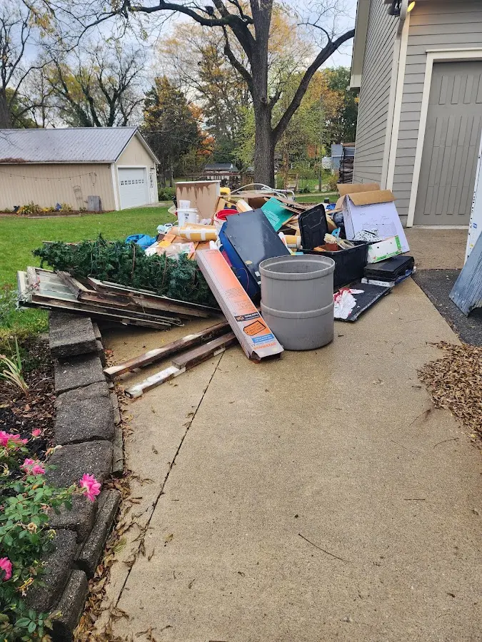 Dumpster being loaded with debris for 12 Yard Dumpster Rental in Elk River